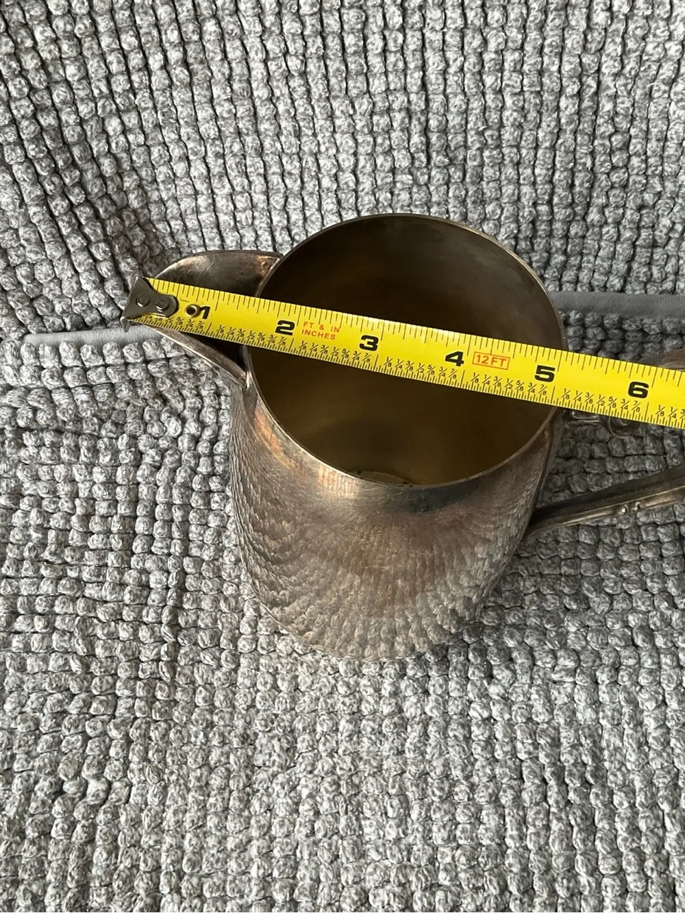 Polished Silver-Tone Decorative Metal Pitcher with Ornate Handle